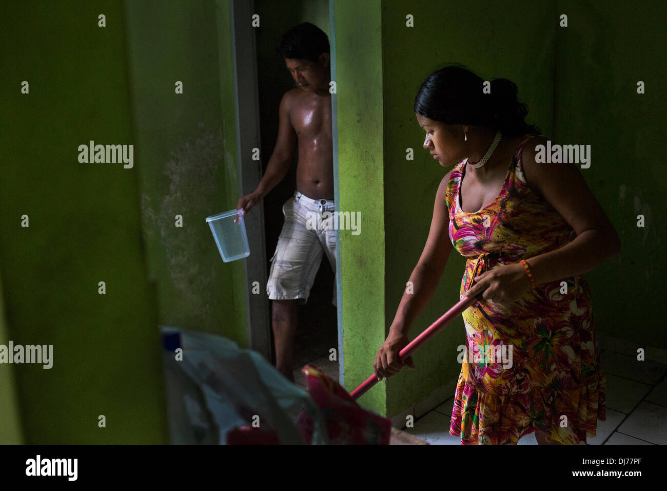 May 14, 2013 - Poti-Kro, Para, Brazil - A Xikrin couple clean a very dirty apartment in a housing space for indigenous visitors in Altamira. Many of members of the Xikrin indigenous tribe complain that they were not consulted about the dam despite a constitutional obligation to do so. Xikrin people live on the Bacaja, a tributary of the Xingu River, where construction of the Belo Monte Dam is reaching peak construction. Some scientists warn that the water level of the Bacaja will decrease precipitously due to the dam. (Credit Image: © Taylor Weidman/ZUMA Wire/ZUMAPRESS.com) Stock Photo