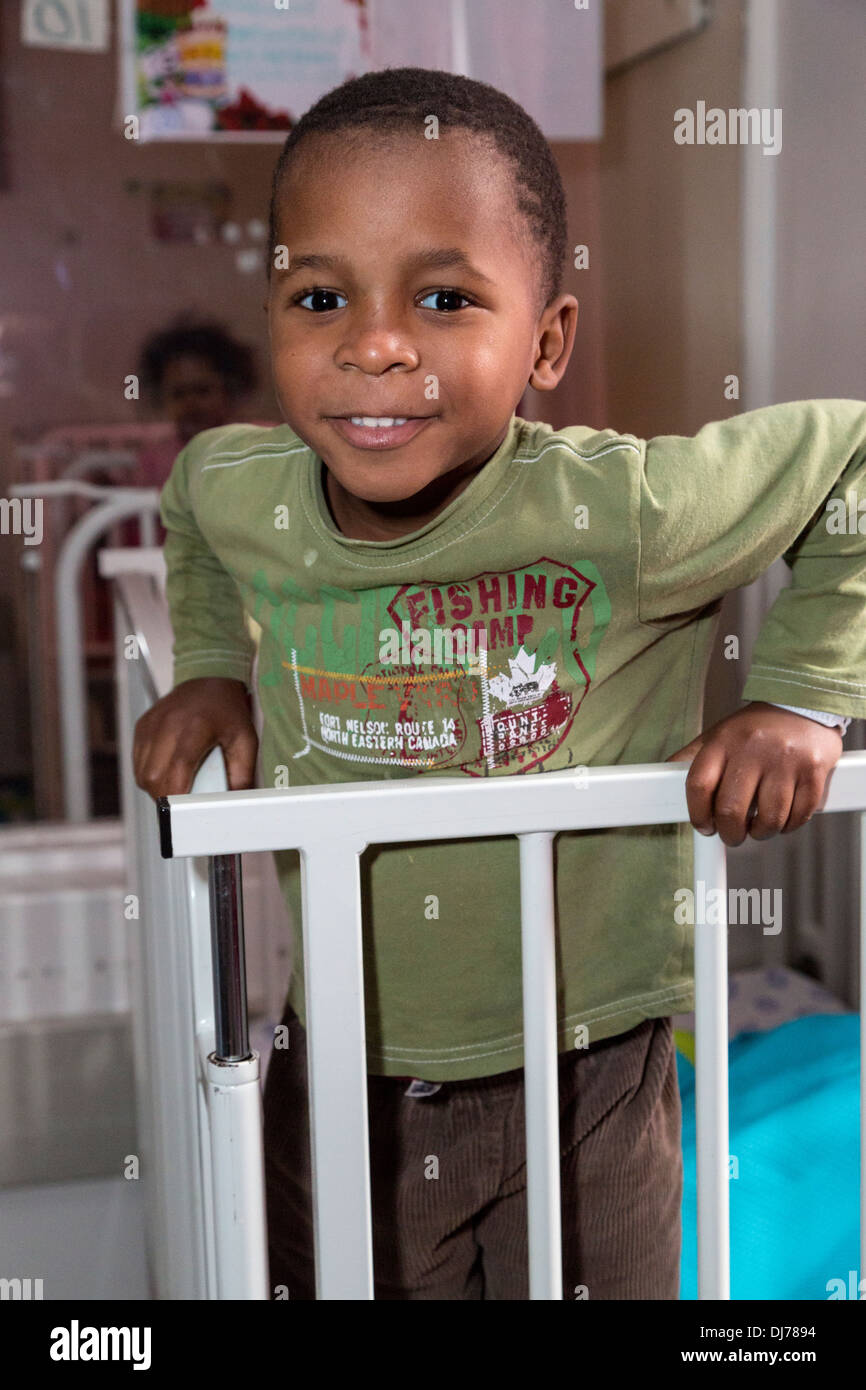 South Africa, Cape Town. Little Boy Standing in his Bed. Stock Photo