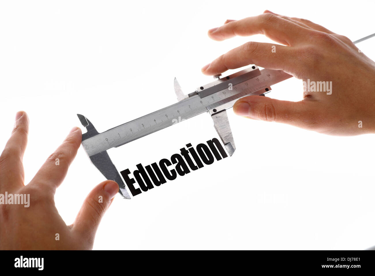 Student Using Calipers Two hands holding a caliper, measuring the word