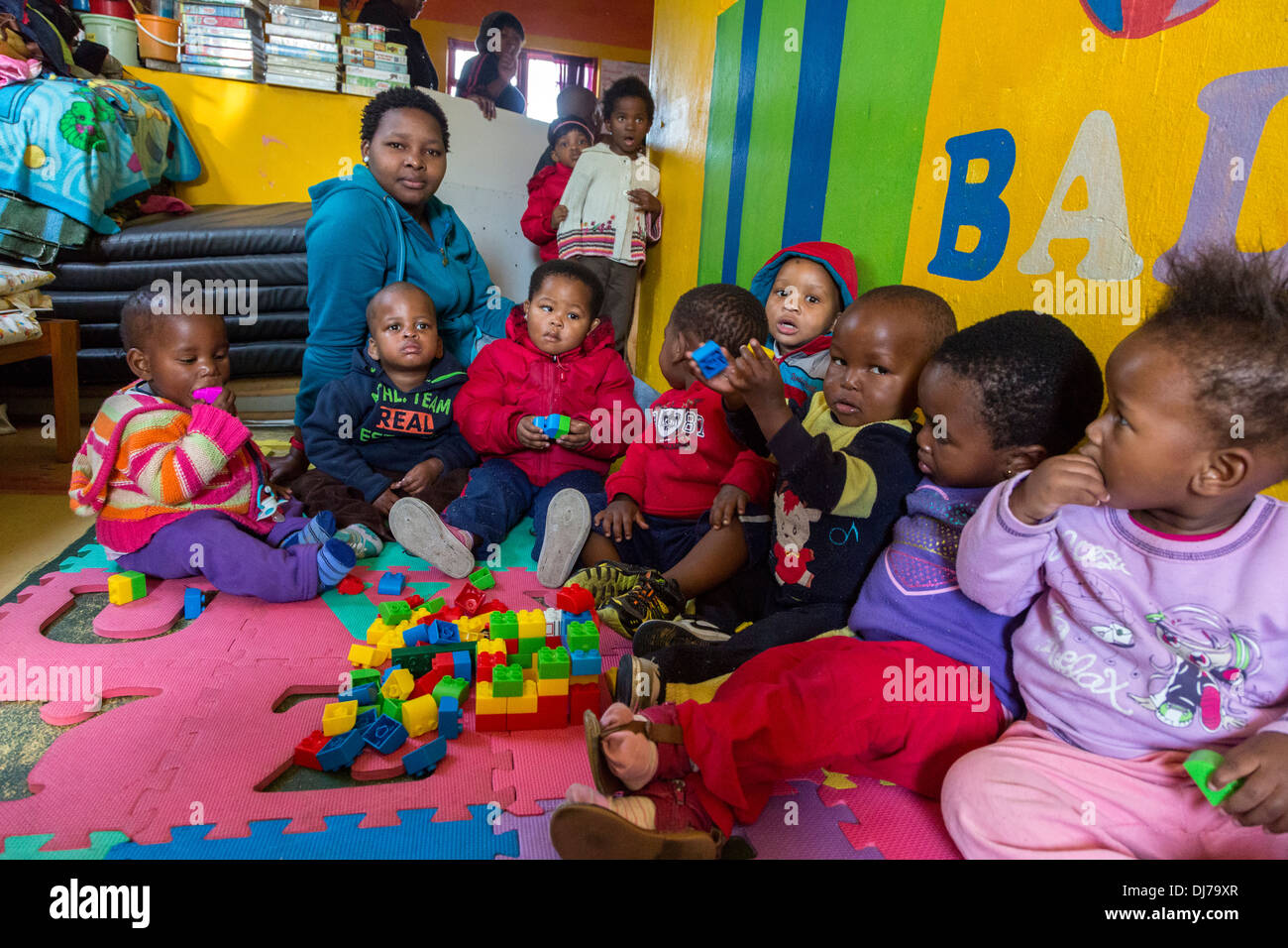 South Africa, Cape Town. Young Children Playing with Plastic Construction Pieces in a Day-care Facility for Young Children. Stock Photo