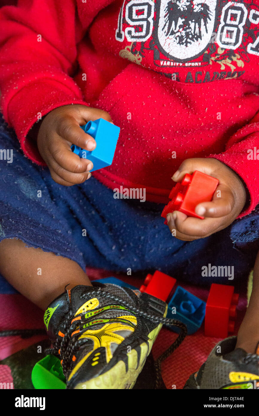 South Africa, Cape Town. Young Boy Playing with Lego Toys in a daycare