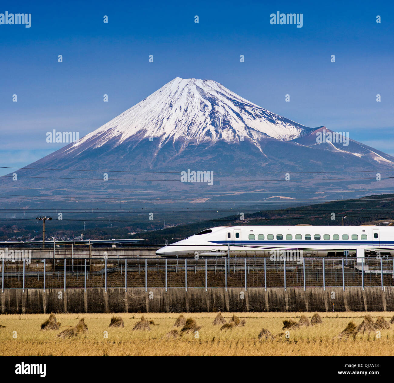 Bullet train passes below Mt. Fuji in Japan Stock Photo