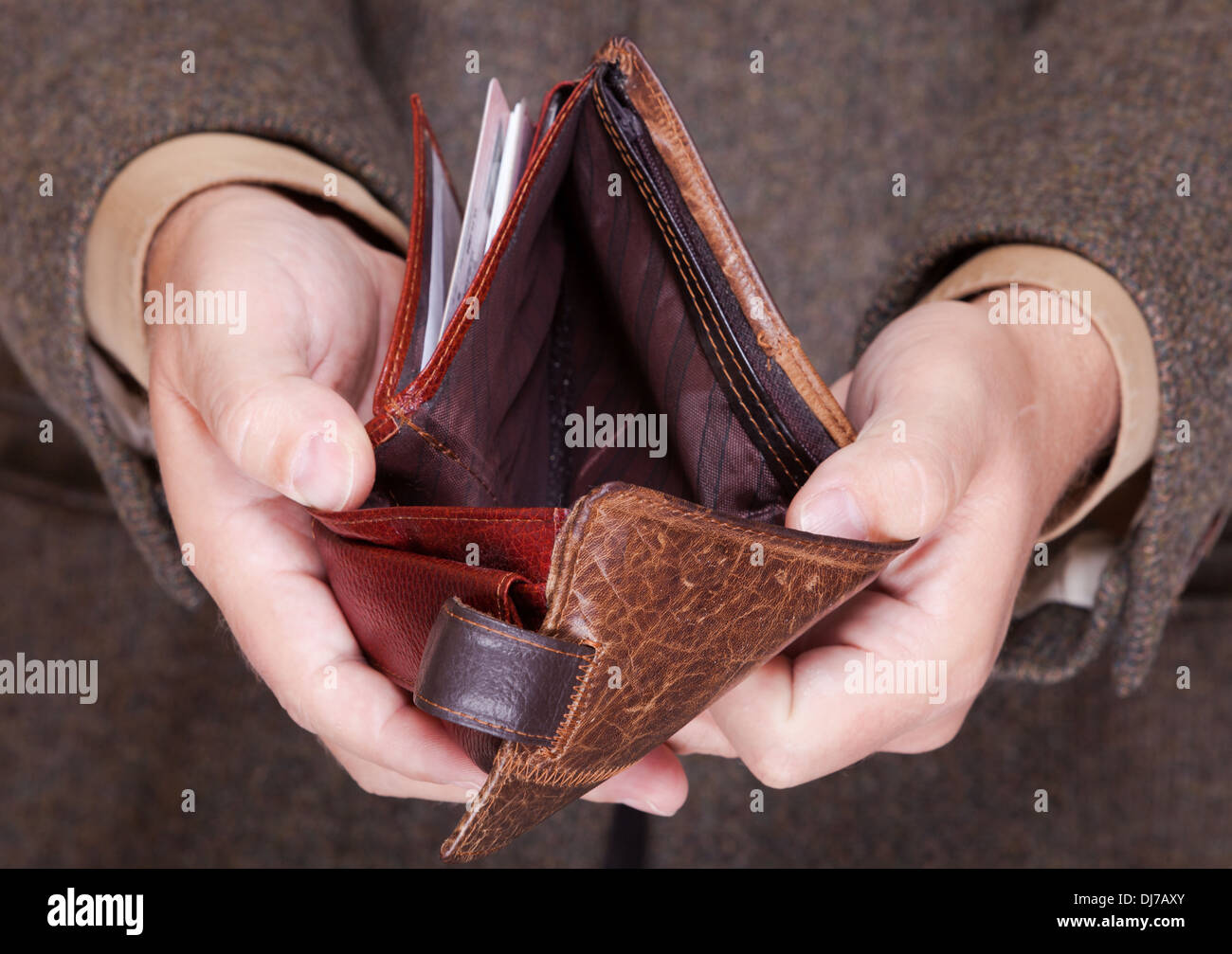 Broke businessman showing brown leather empty wallet. Business concept ...