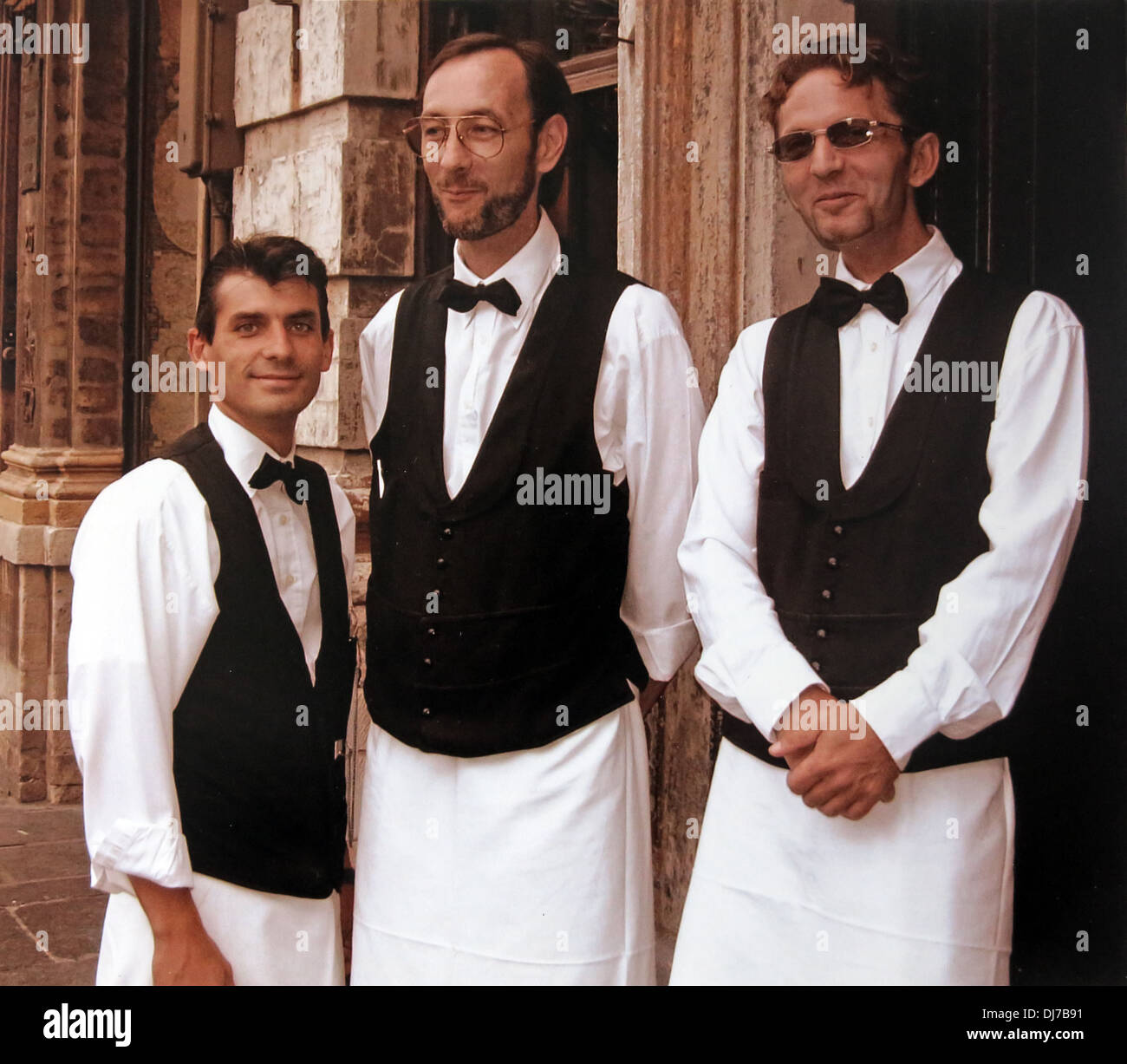 Three cool waiters, les garcons, French restaurant, Brussels, Belgium, Europe. Serving is a career in many countries, not a low paid job Stock Photo