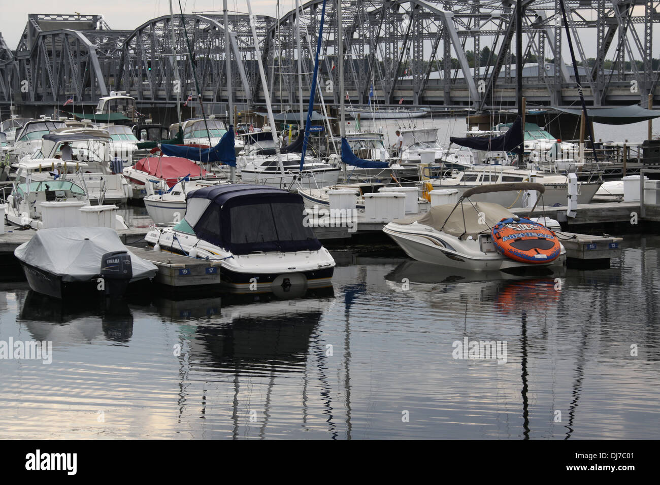Boats in a marina in Sturgeon Bay, WI with the city's steel bridge in the background Stock Photo