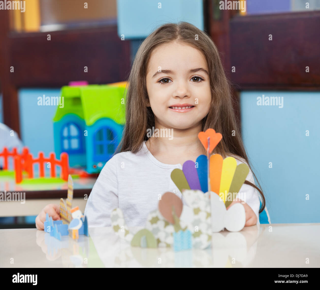 Cute Girl With Craft On Desk In Classroom Stock Photo - Alamy