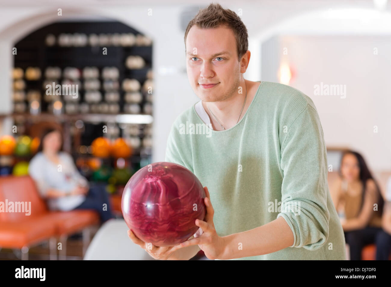 Man Holding Bowling Ball in Club Stock Photo Alamy