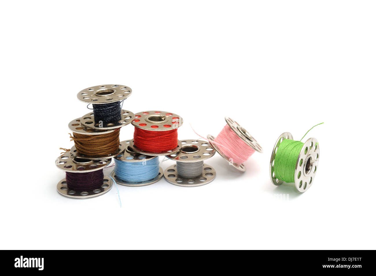 Different colored Sewing machine bobbins Stock Photo