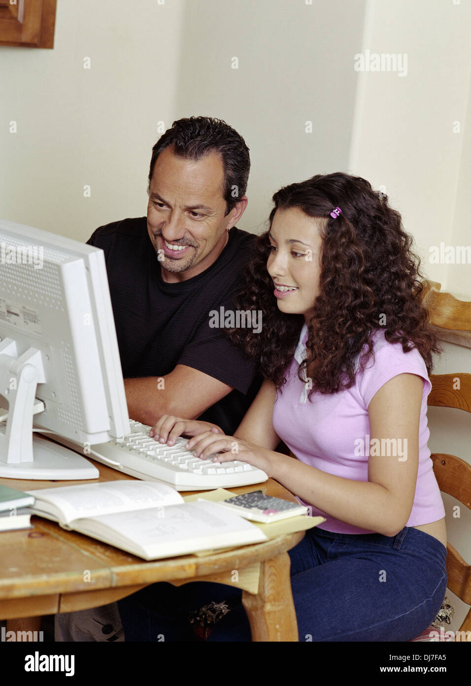 Hispanic Father Helping Daughter Use Computer Stock Photo - Alamy