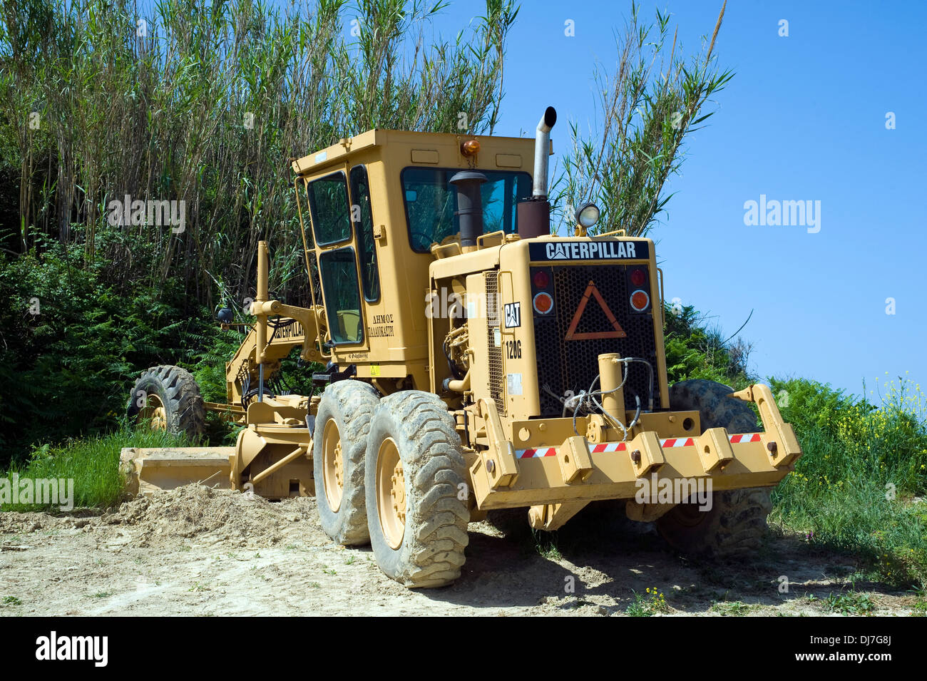 Caterpillar Earth moving machine for leveling roads, Corfu, Greece. Stock Photo