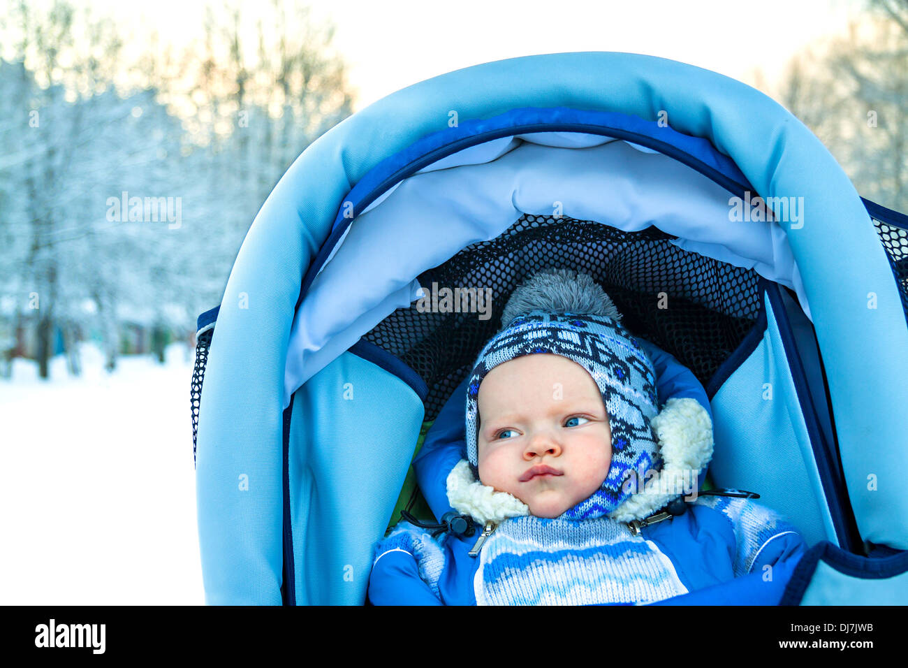 small child in the winter on walk in park Stock Photo