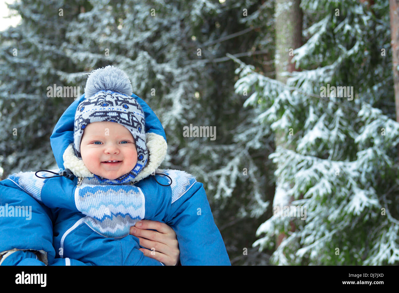 the happy small child in the winter on walk in park Stock Photo