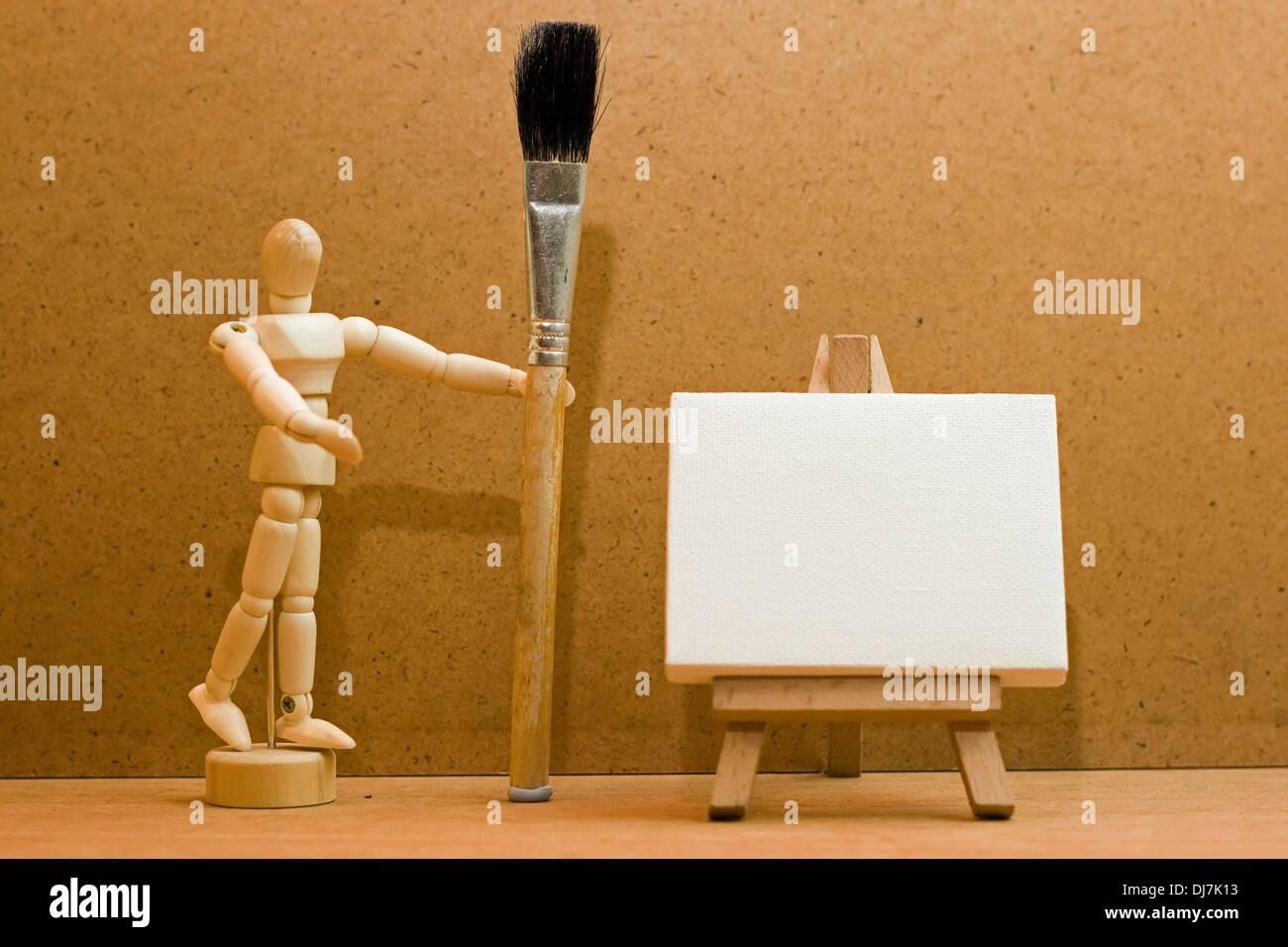 Artists' manikin with a paint brush and easel Stock Photo Alamy