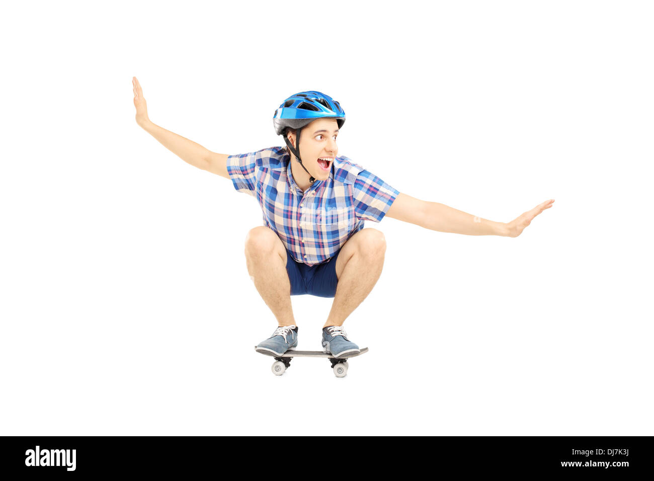 Young smiling male with helmet skating on a skate board Stock Photo Alamy