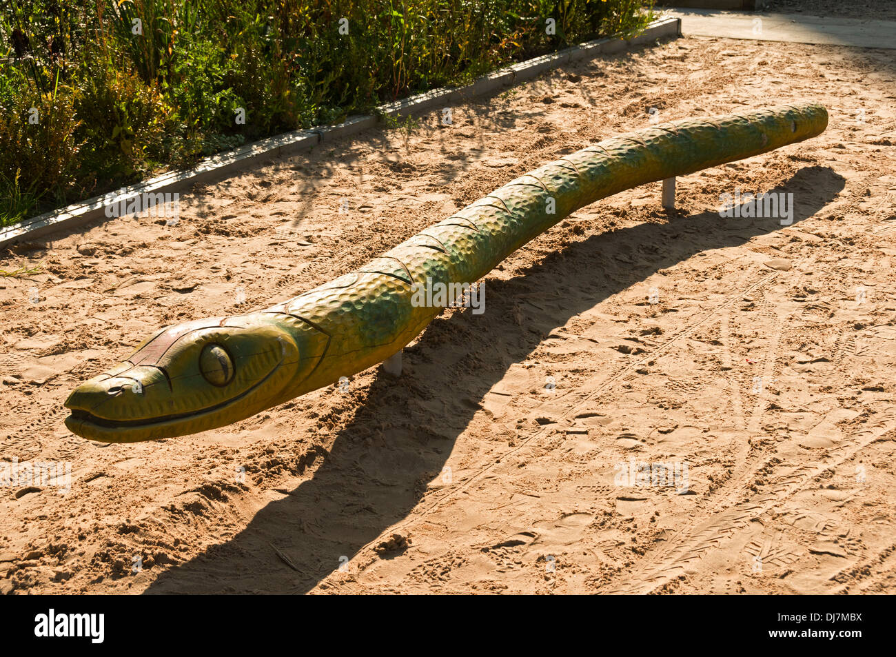 A wooden carved snake at a children's play area, Victoria Street, Manchester, England, UK Stock Photo