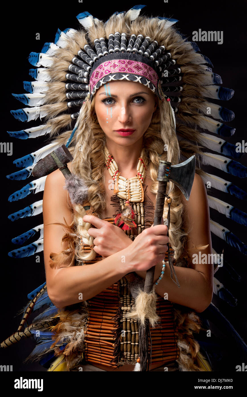 Premium Photo  A woman in a native american costume with feathers on her  head.