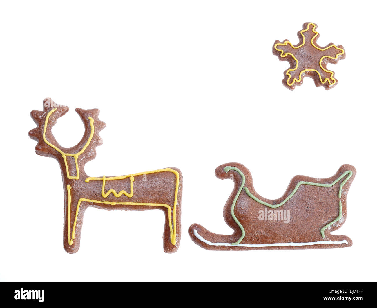 Gingerbread reindeer sleigh and star with color icing shot on white background Stock Photo