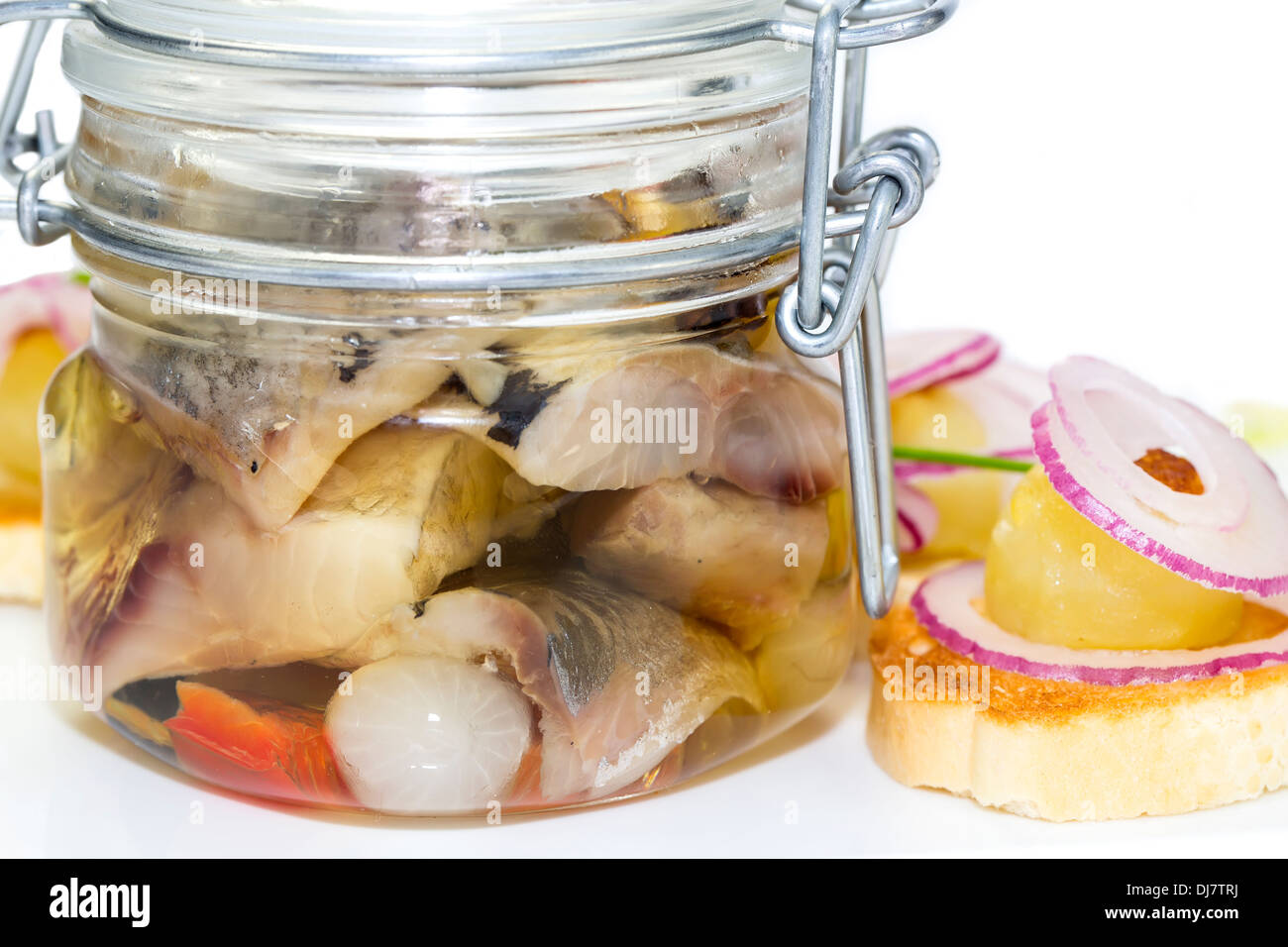 pickled herring in a glass jar with potato canapes Stock Photo Alamy