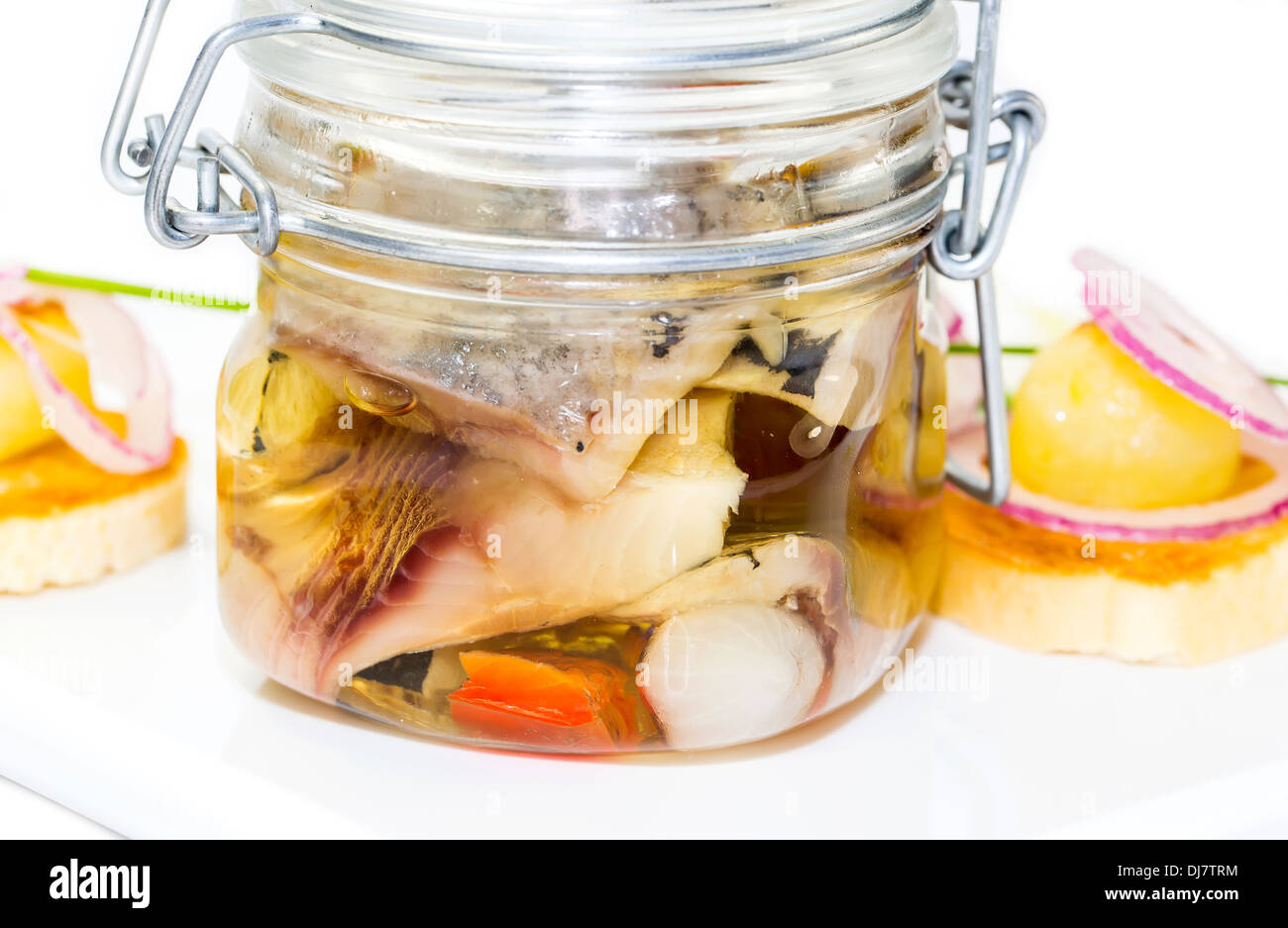 pickled herring in a glass jar with potato canapes Stock Photo Alamy