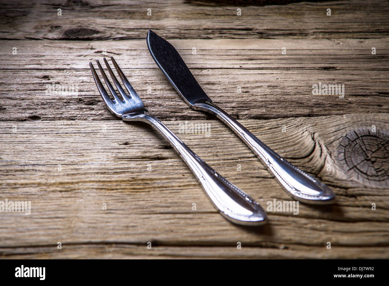 Fish cutlery on rustic wooden table Stock Photo