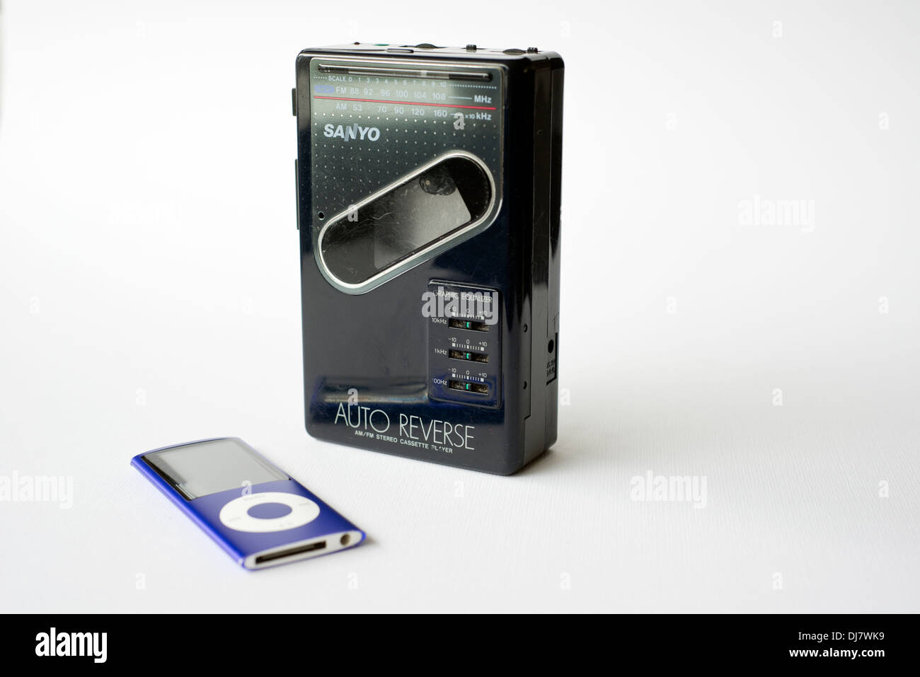 An old Sanyo walkman personal cassette player including radio, alongside a modern Apple iPod Nano Stock Photo