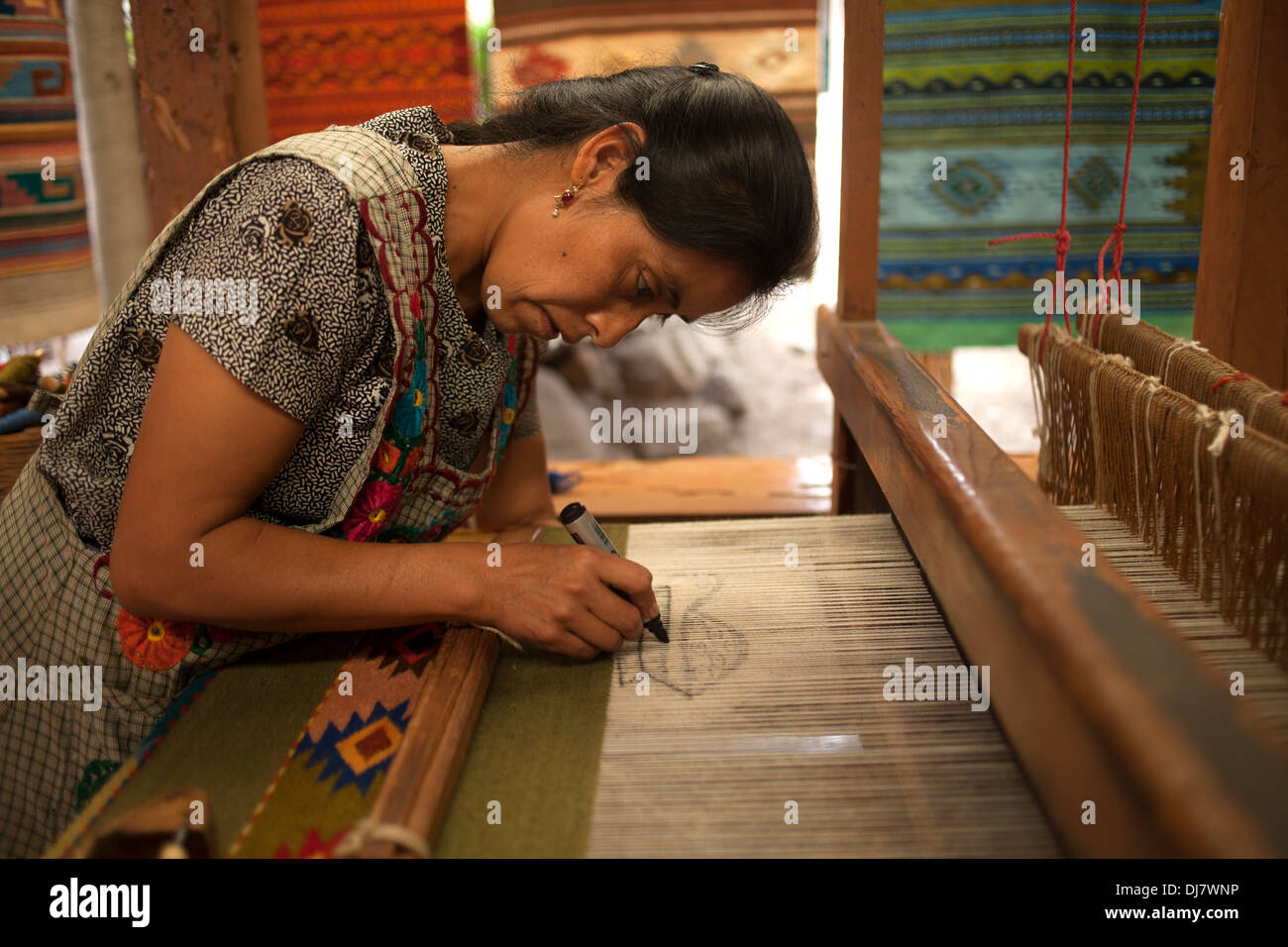 A woman works in a weaving studio in Teotitlan del Valle, Oaxaca