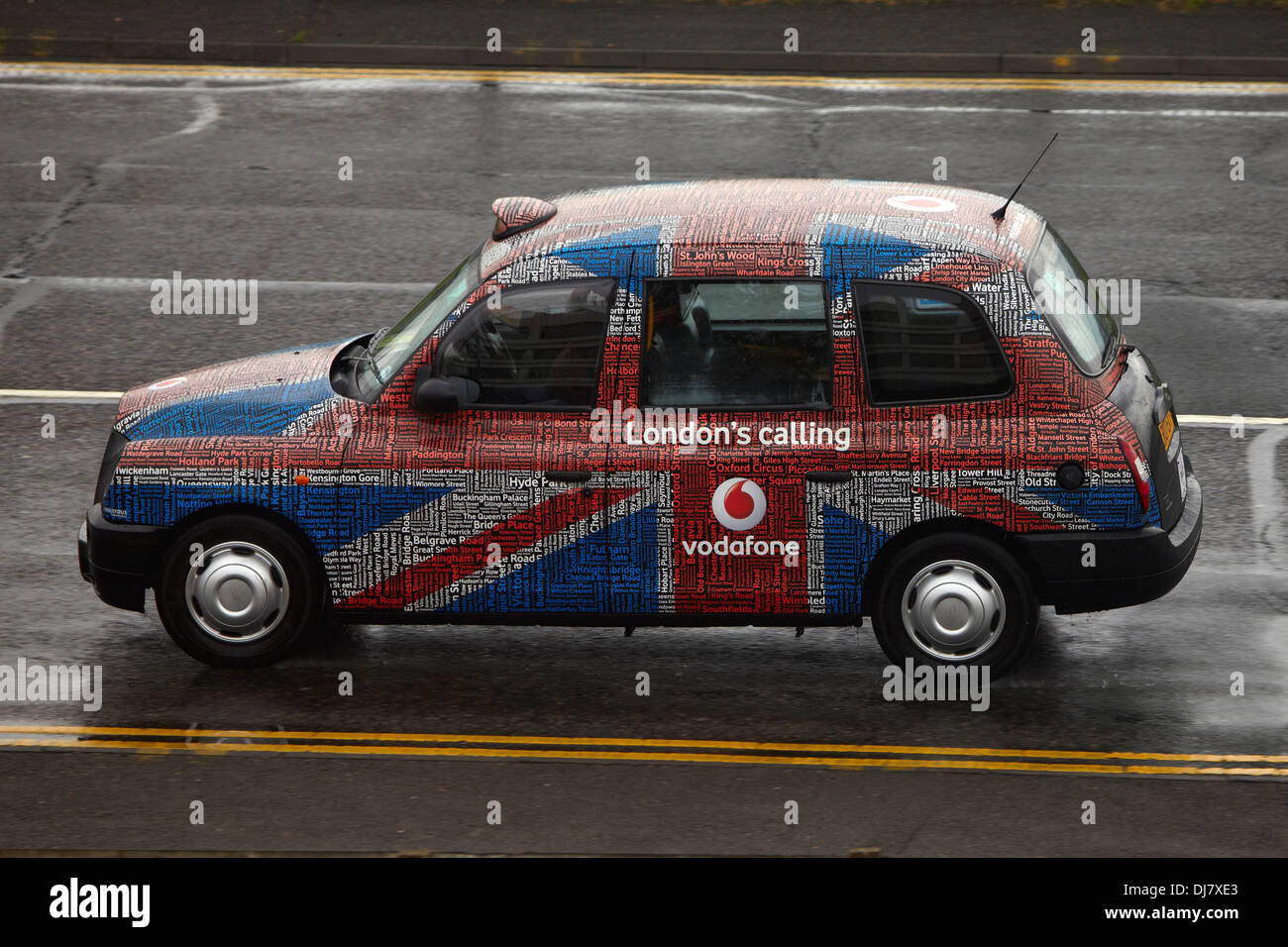 A hackney or hackney carriage (also called a cab, black cab, hack or London taxi) driving in London Stock Photo