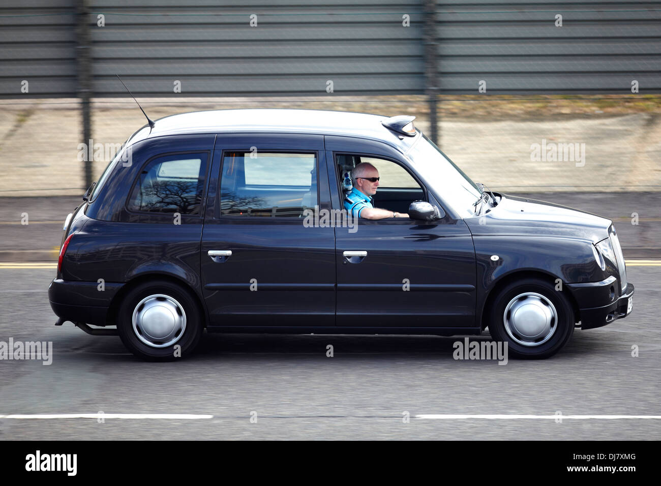 A hackney or hackney carriage (also called a cab, black cab, hack or London taxi) driving in London Stock Photo