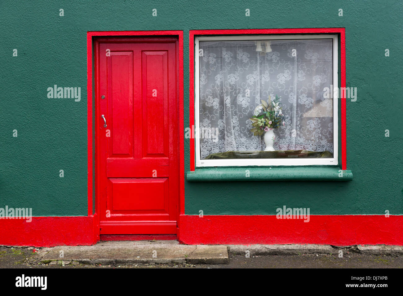 Red painted door and window on street, Kilfenora, Co. Clare, Ireland Stock Photo