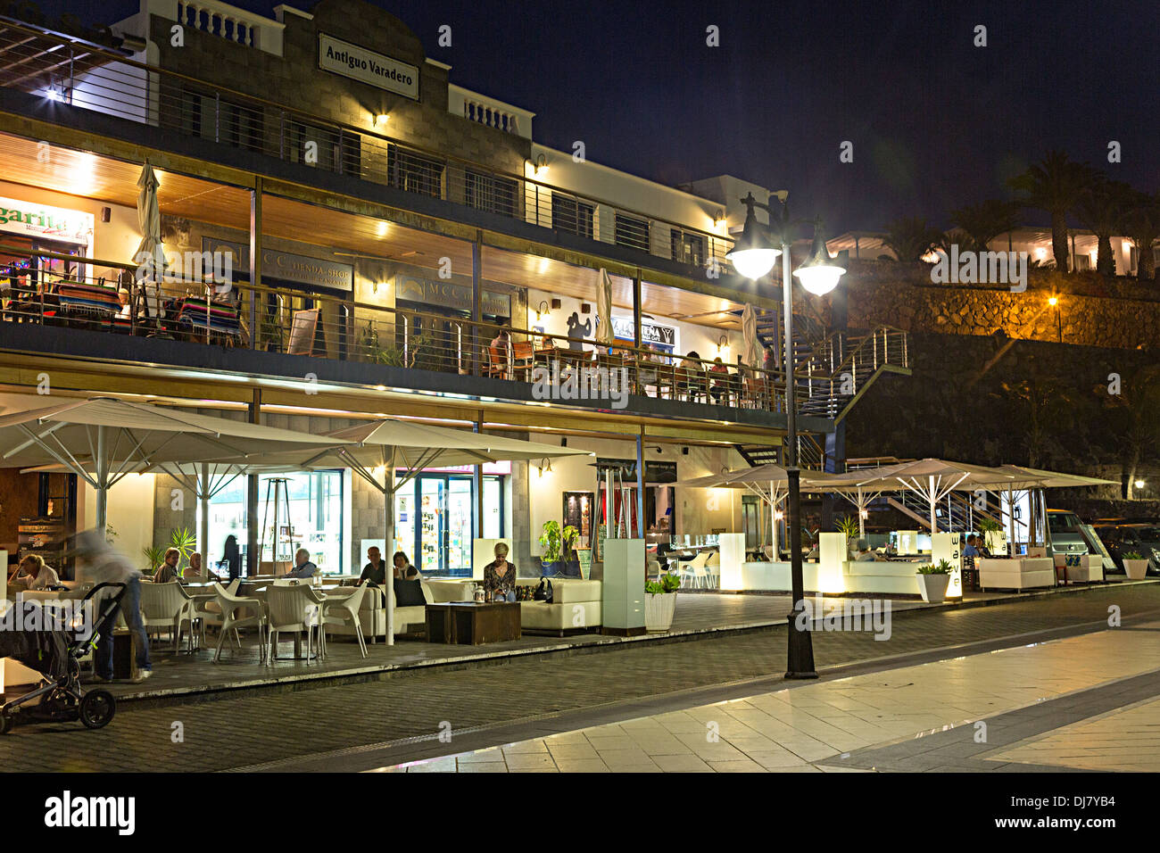 People sitting outside at bars and restaurants, Puerto Calero, Lanzarote, Canary Islands, Spain Stock Photo