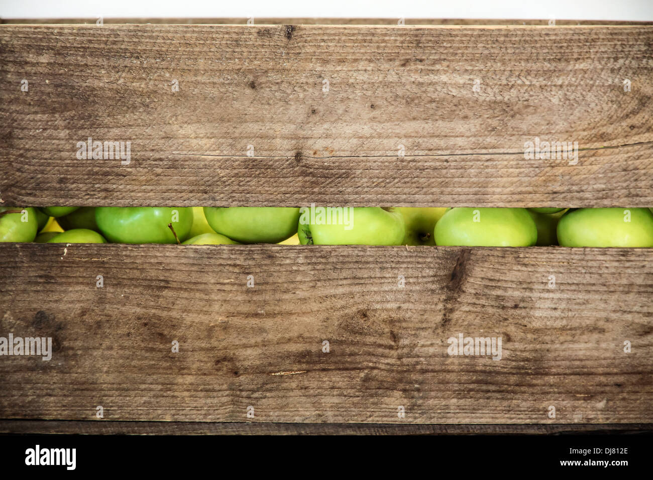 Green apple in a wooden box, only to see a gap Stock Photo
