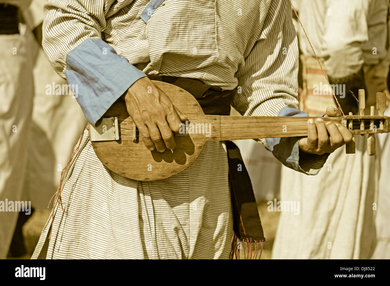 Yobin man with his traditional guitar at Namdapha Eco Cultural Festival, Miao, Arunachal Pradesh, India Stock Photo