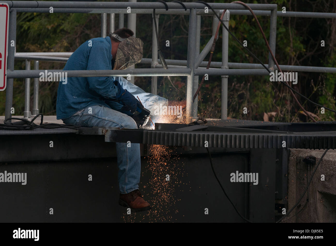 Man welding on the Burrell Navigational Lock located on Haines Creek in Lake County, Florida Stock Photo