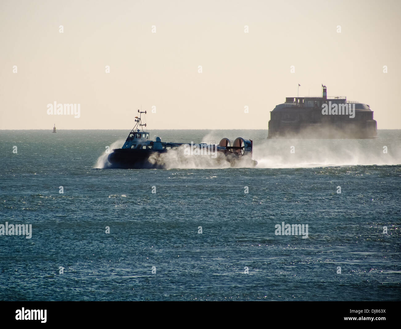 The Portsmouth to Isle of wight Hovercraft crossing the Solent with Spitbank fort in the background Stock Photo