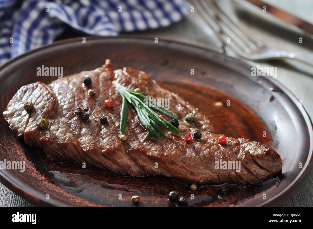Grilled steak on plate with spices and rosemary closeup Stock Photo