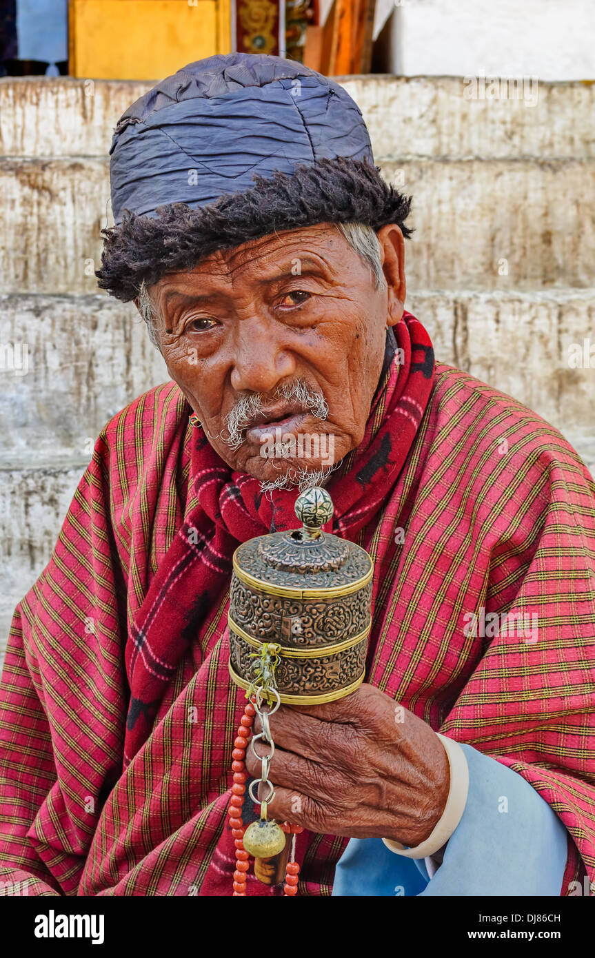 Old Bhutanese Buddhist man praying Stock Photo
