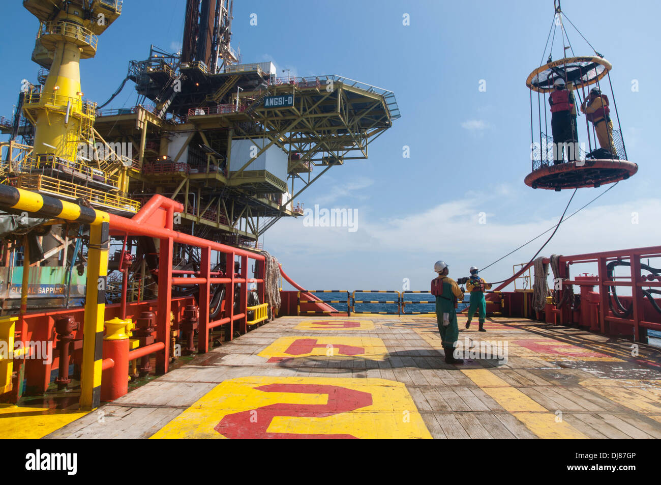offshore vessel crew working on deck for transfer platform crew to vessel by personal basket Stock Photo