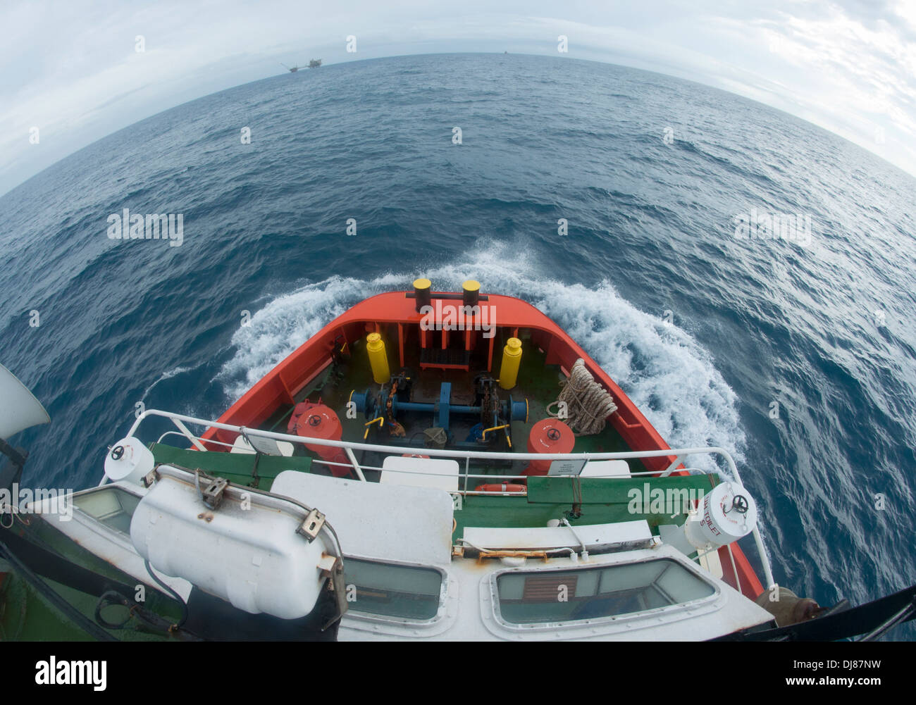 supply boat en route to platform at open sea Stock Photo