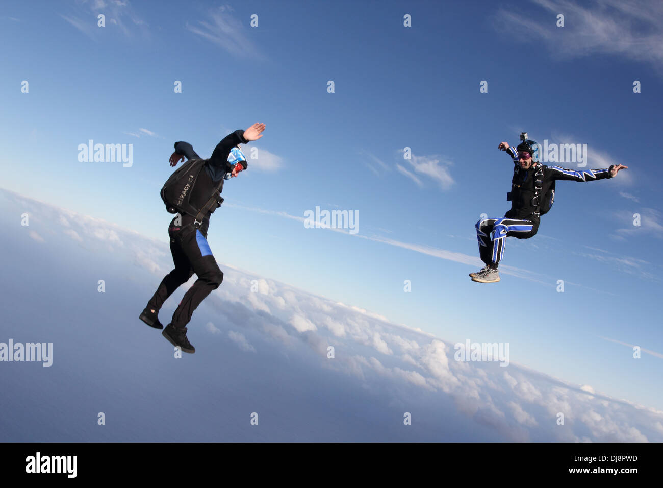 This freefly skydive team is training together for the next competition. It is fun for all to fly free over the clouds. Stock Photo