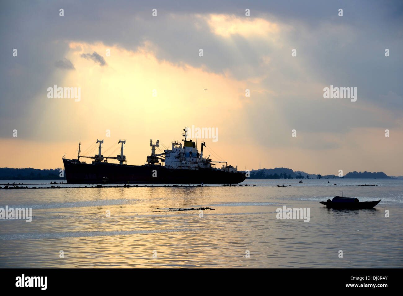 Ship at sunset dusk Stock Photo - Alamy
