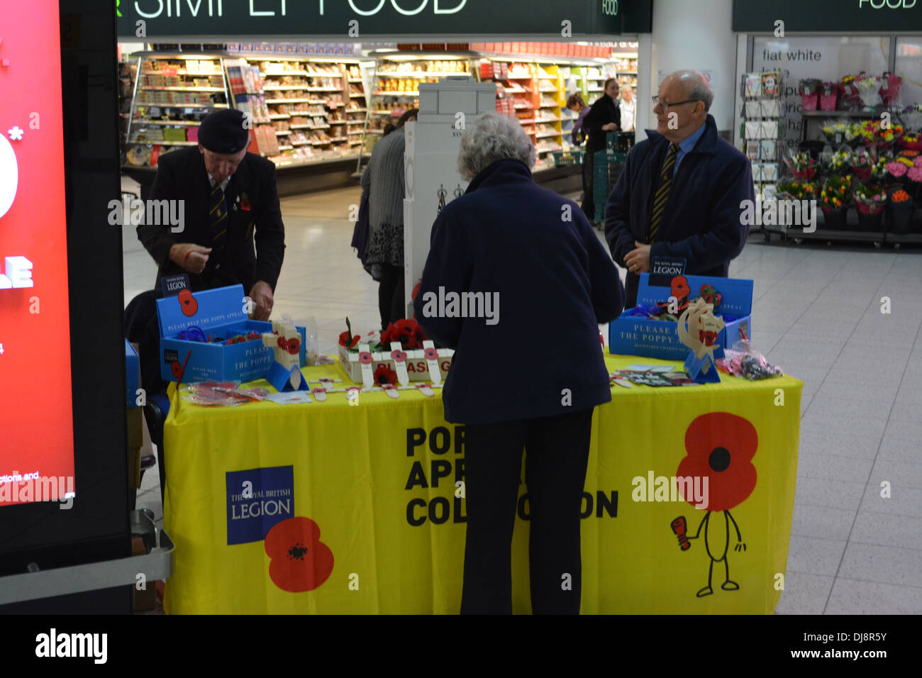 War veterans doing poppy appeal collection at Gatwick Airport. Stock Photo