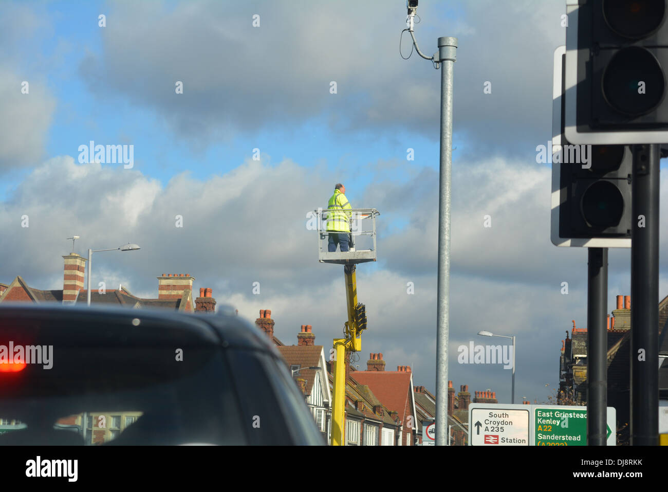 Man repairing street light up a crane Stock Photo Alamy
