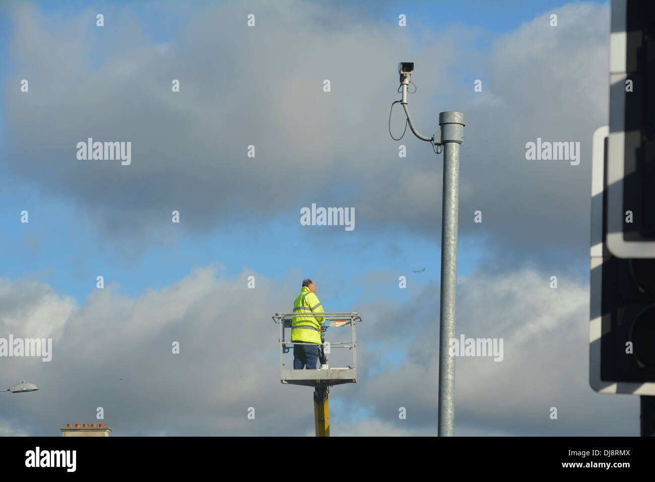 Man repairing street light up a crane Stock Photo Alamy