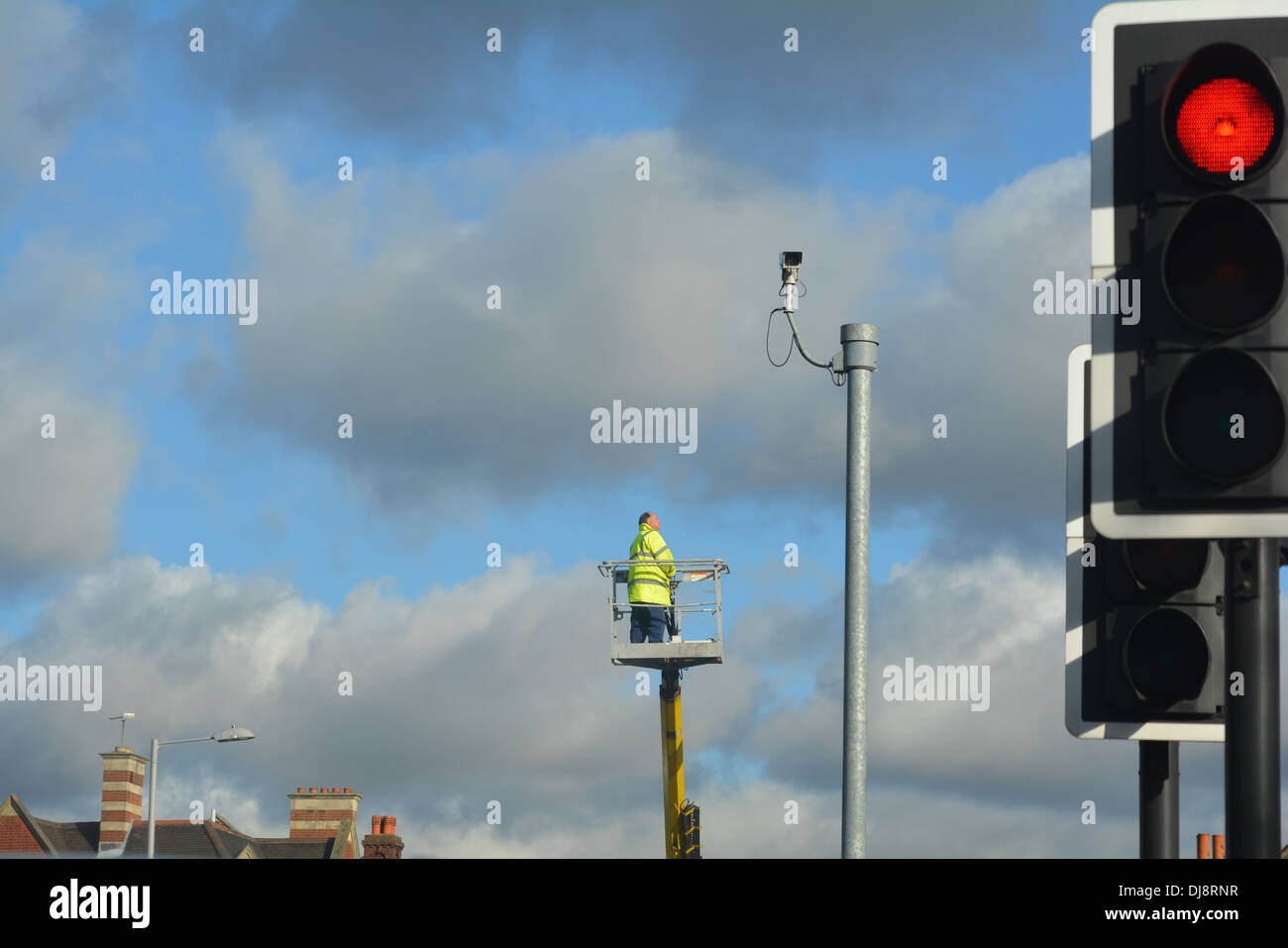 Man repairing street light up a crane Stock Photo Alamy