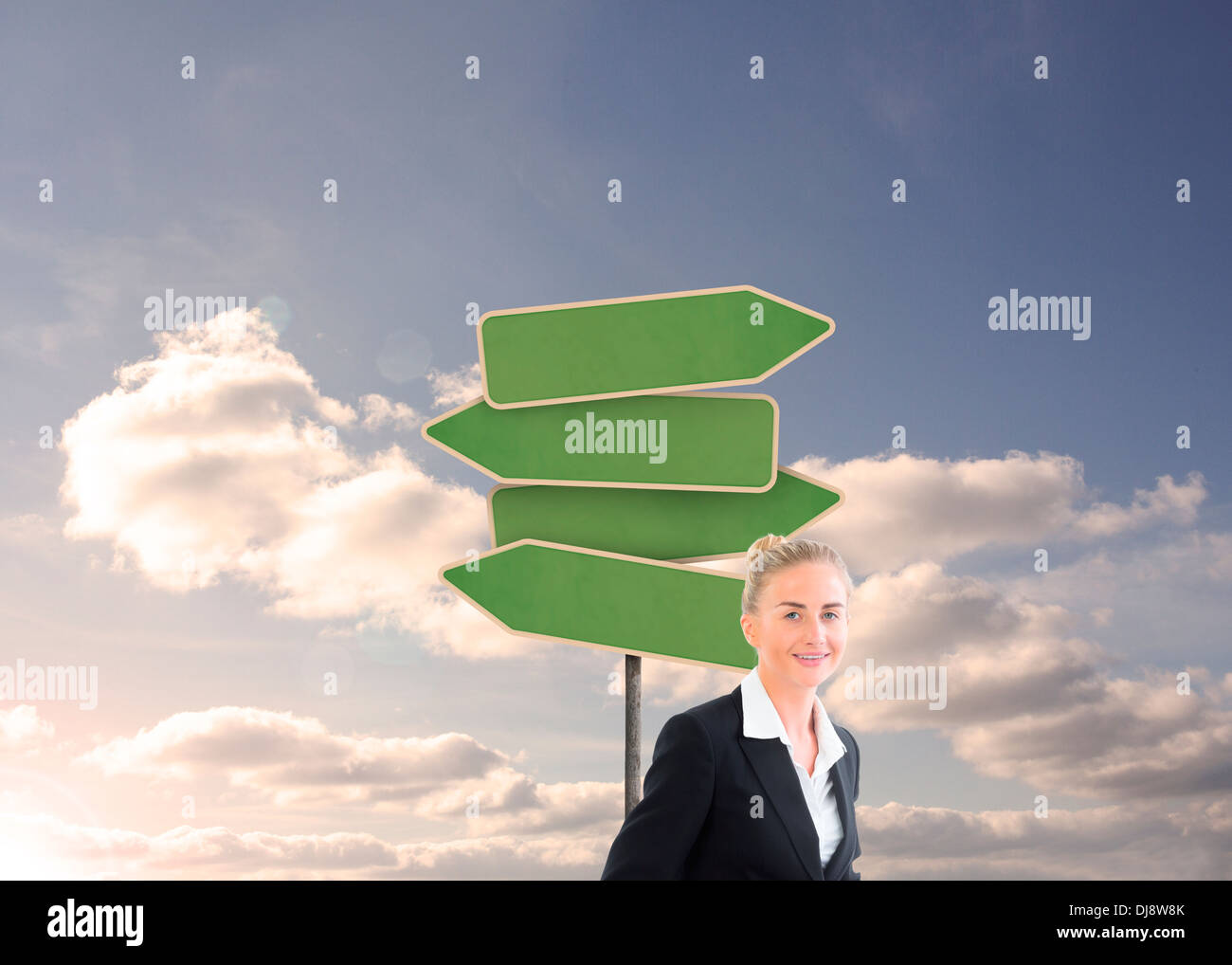 smiling businesswoman with direction arrow sign Stock Photo - Alamy