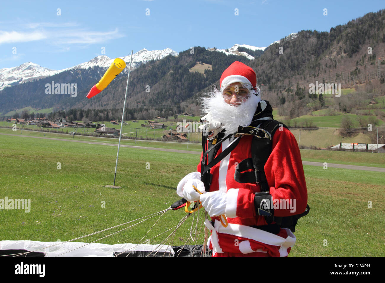 Santa Clause landed with his parachute and now he is very happy to be
