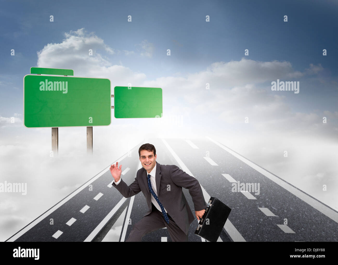 Happy businessman holding a briefcase and running Stock Photo