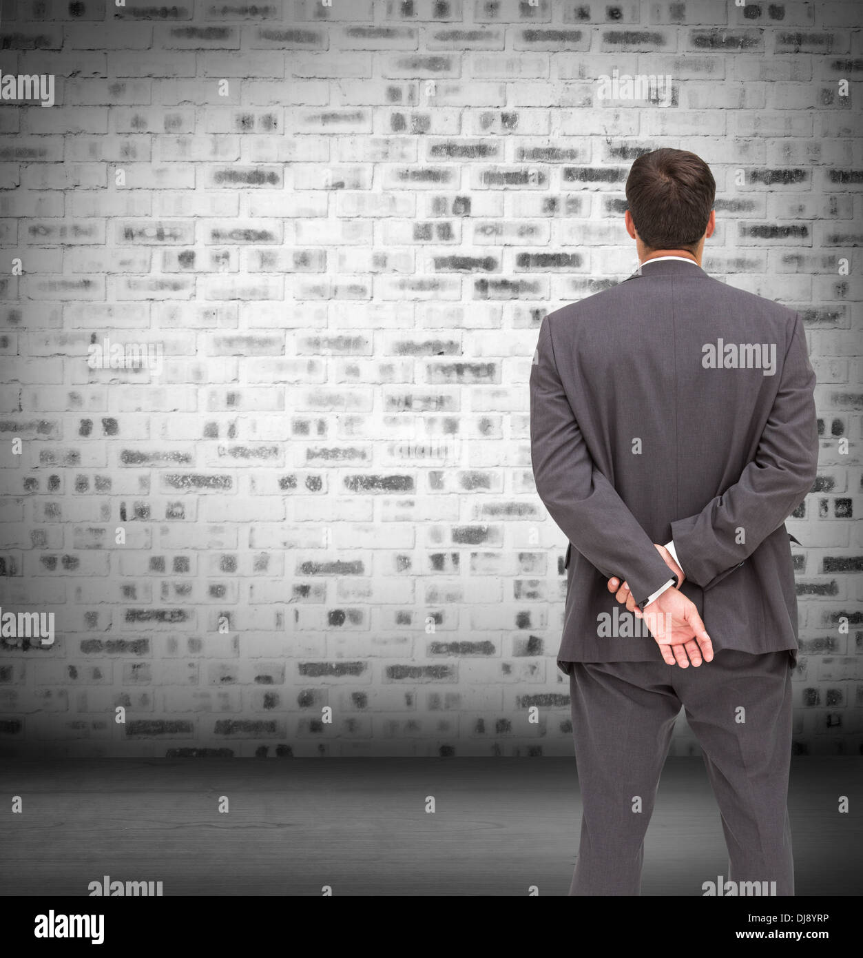 Businessman standing with hands behind back Stock Photo Alamy
