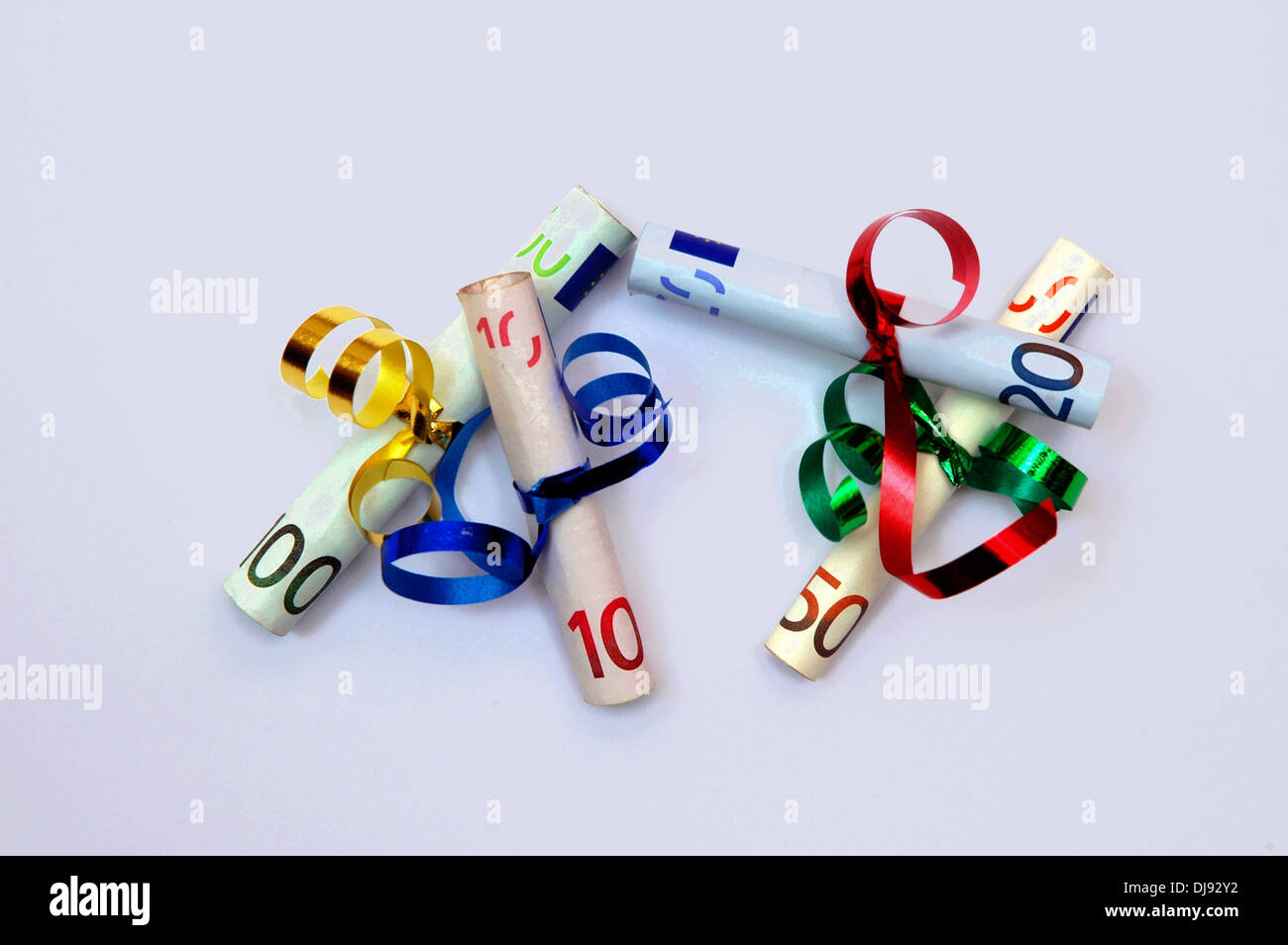 Bank Notes Ribbons (ILLUSTRATION) Colorful ribbons are wrapped around rolled banknotes on ...