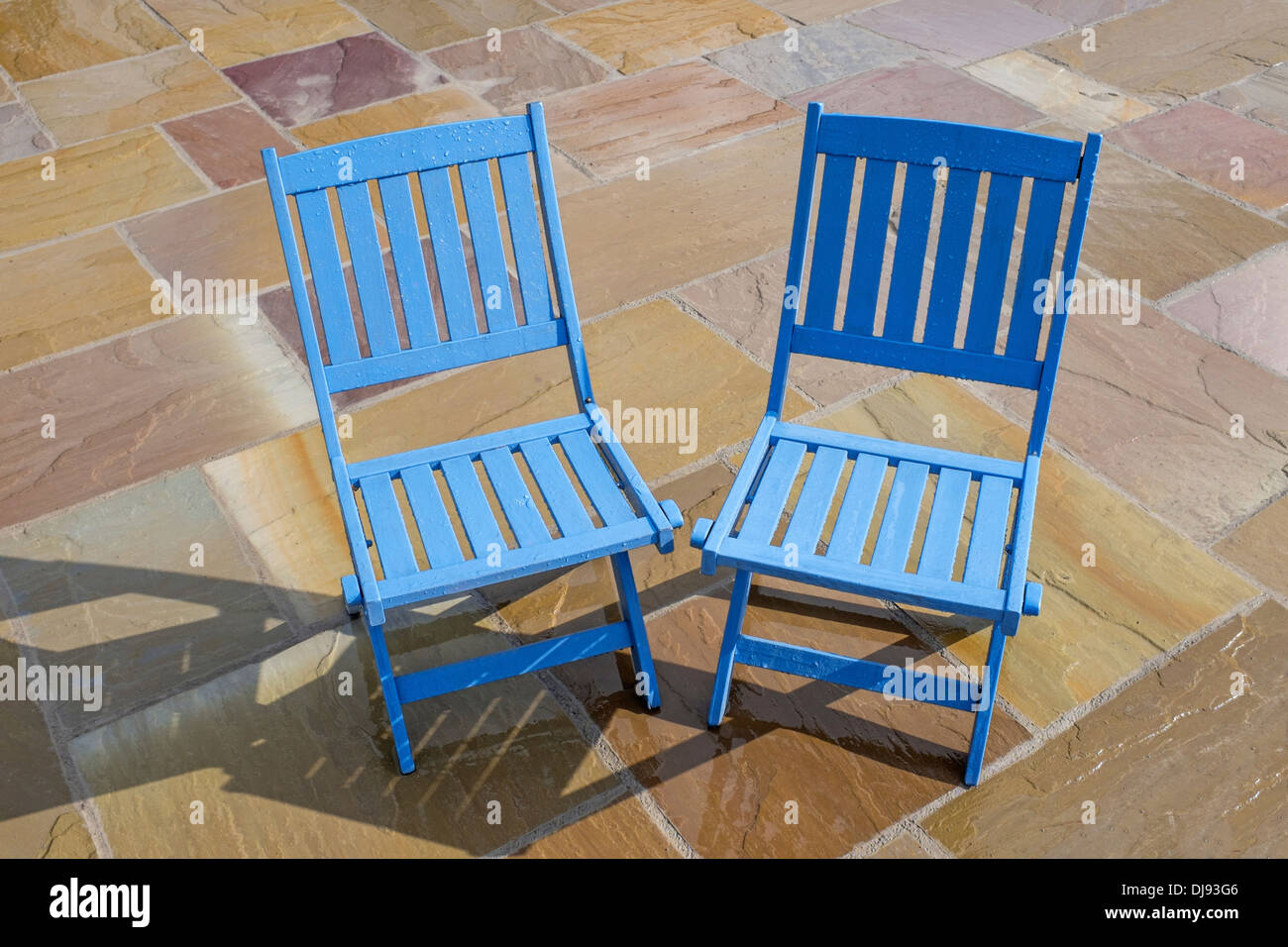 Blue chairs on a wet patio Stock Photo Alamy